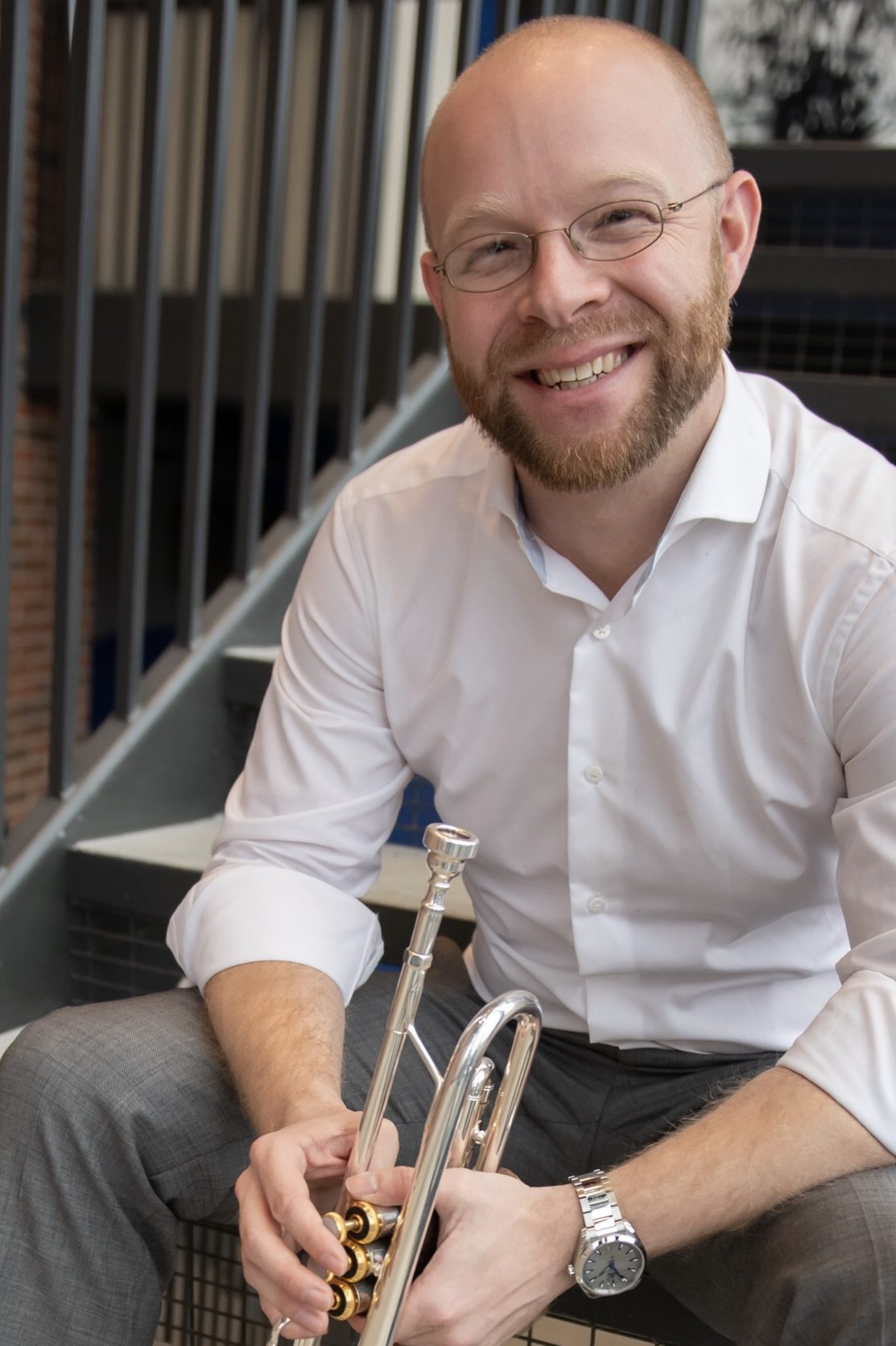 Dr. Andrew Harms holding a trumpet